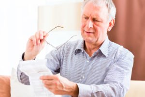 Man reading a sheet with side effects