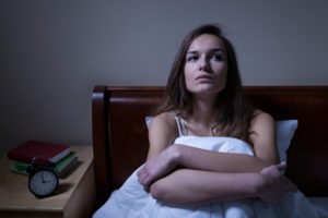 Woman laying awake in bed