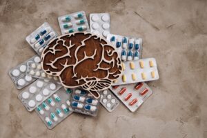 Image of wooden brain with pills