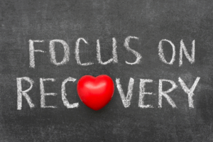 Chalkboard sign with words Focus on Recovery