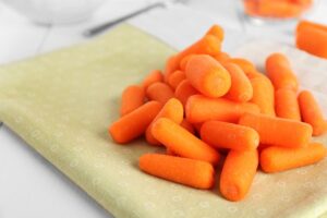 Photo of baby carrots on a napkin