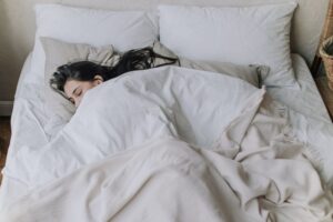 Blanket on top of woman who is sleeping