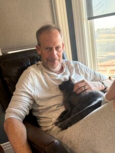 Sam and Willow the cat sitting on a chair