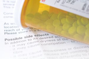 Suzy Cohen 63 Pill bottle on paper that says "side effects"