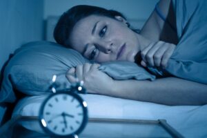 woman waking up in the middle of the night with insomnia