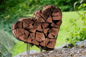 Heart made of pieces of wood that are broken representing broken heart syndrome
